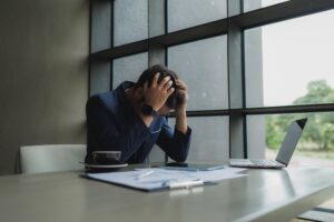 Employee struggling with excessive workload and reduced workforce performance