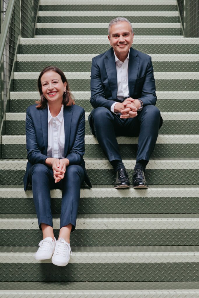 Suzy and Jean-Philippe Glaskie, Co-Founders of Rowan & Rock, seated on steps